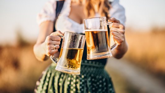 German woman at October Fest holding to beer mugs full of beer