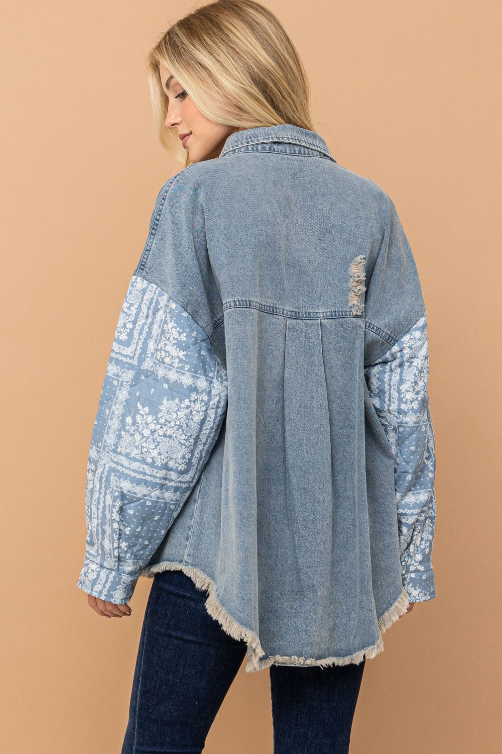 woman wearing high-low denim shacket with paisley pattern back view