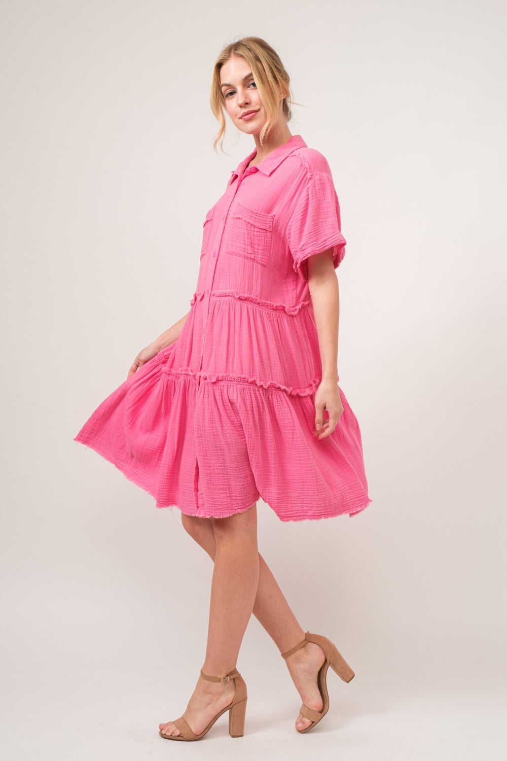 woman wearing cotton shirt dress in pink side view