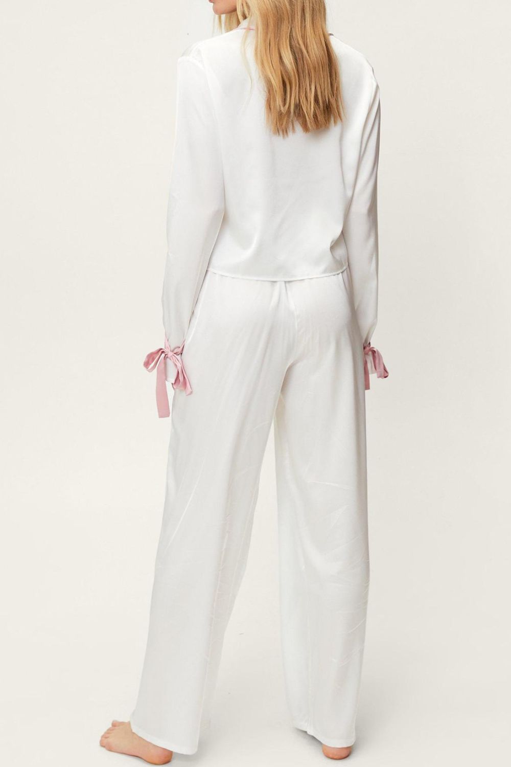 woman wearing silky lounge pant set in white