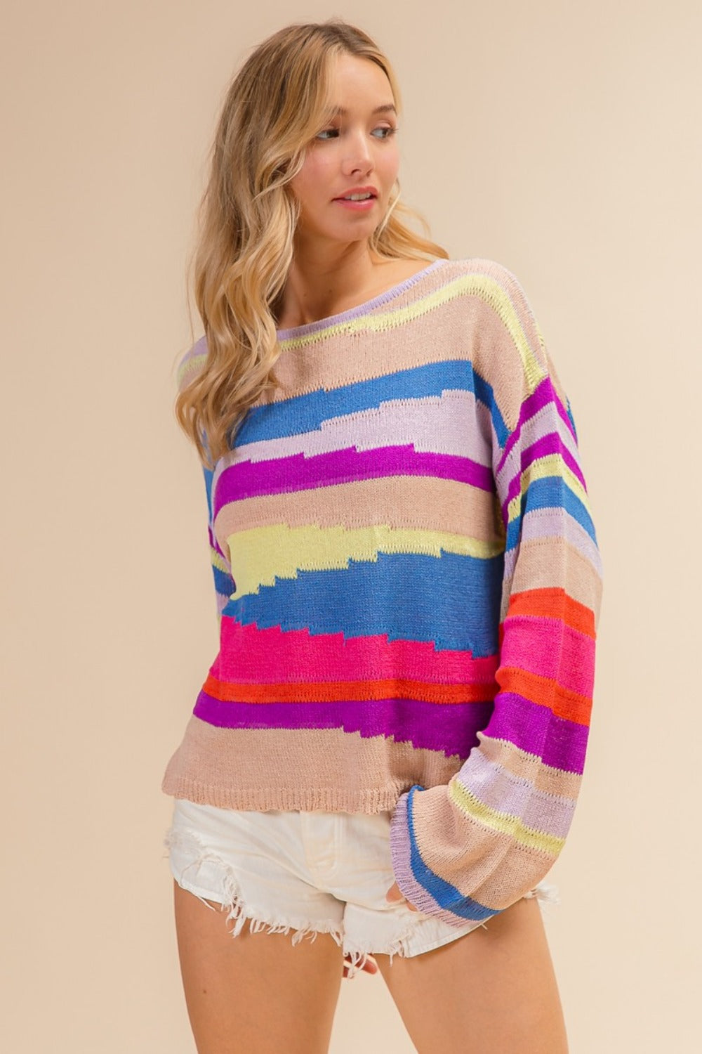 woman wearing colorful knitted rainbow mountain sweater