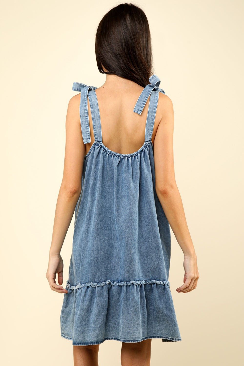 woman wearing denim mini dress back view