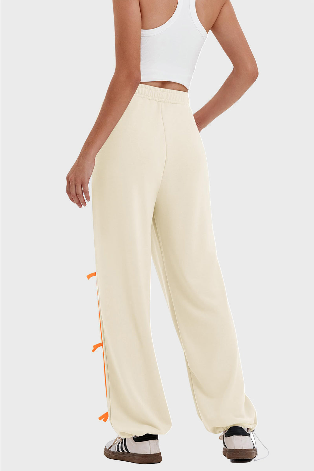 woman wearing bow striped track pants in cream