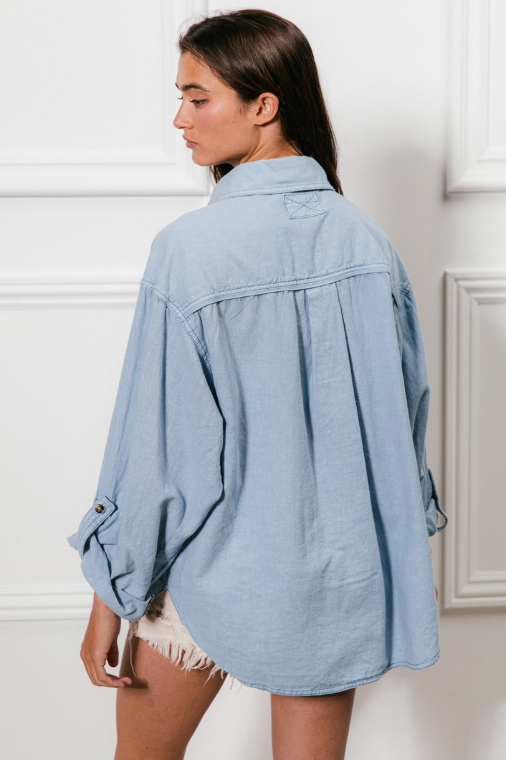 woman wearing relaxed fit denim shirt