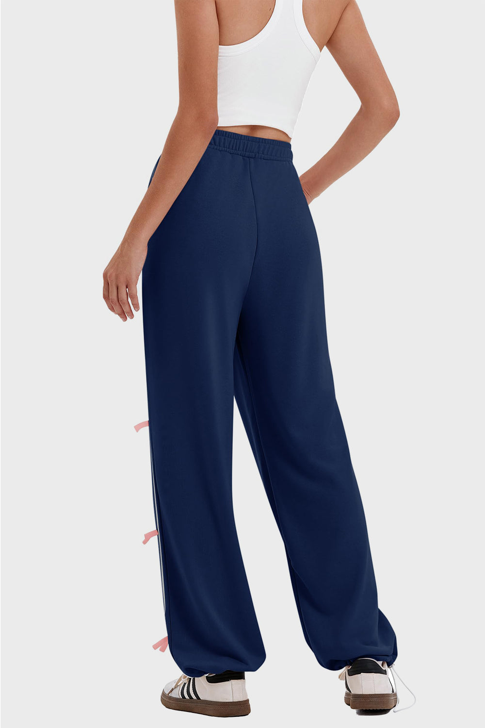 woman wearing bow striped track pants in navy