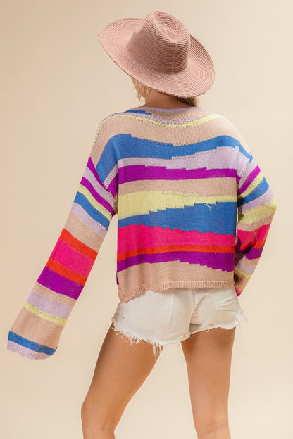 woman wearing colorful knitted rainbow mountain sweater