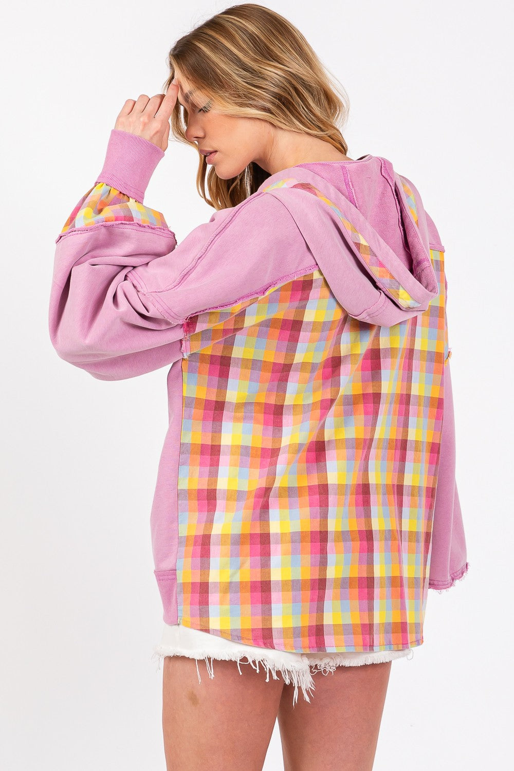 woman wearing pink hoodie with plaid back view