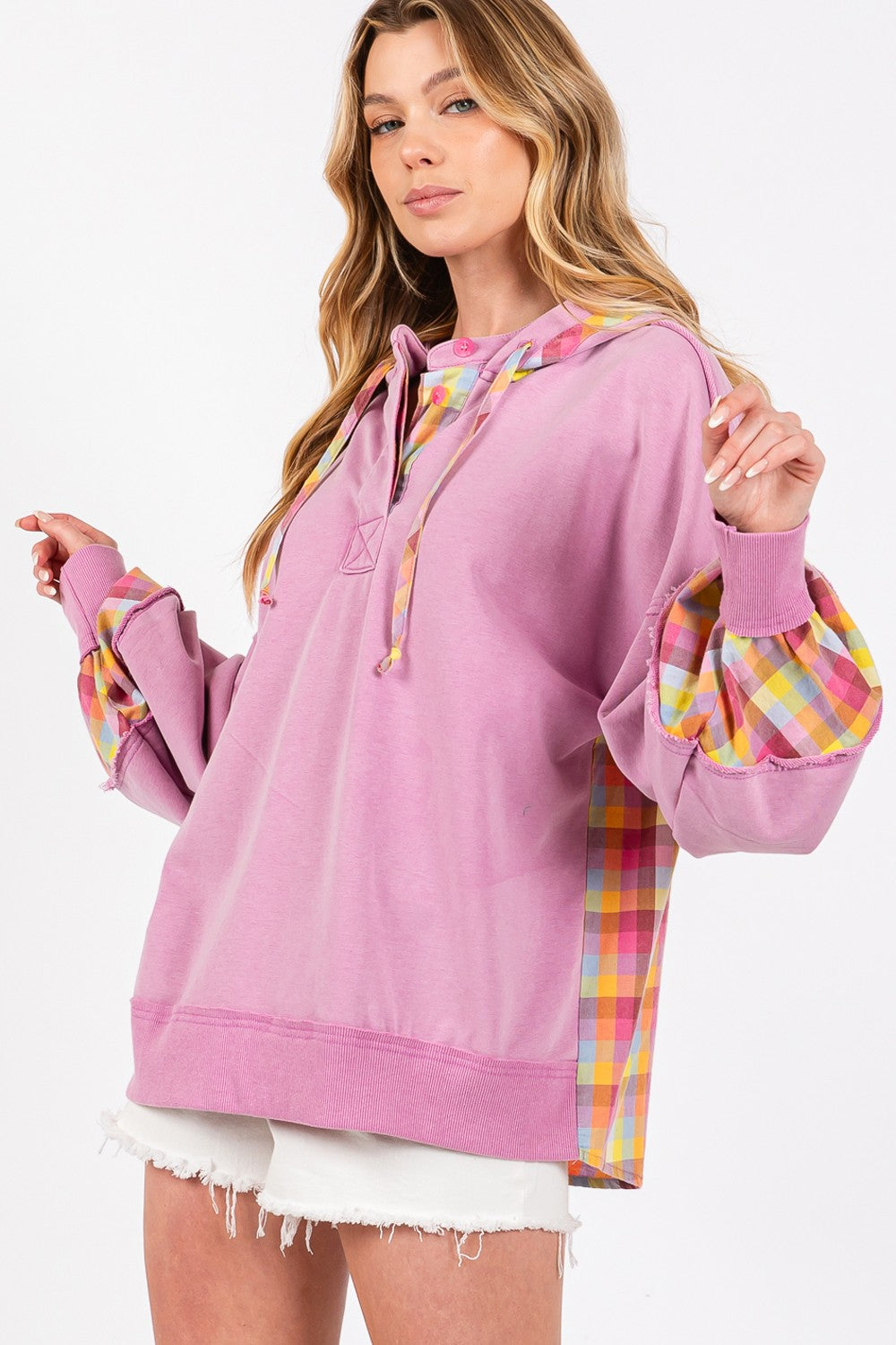 woman wearing pink hoodie with plaid