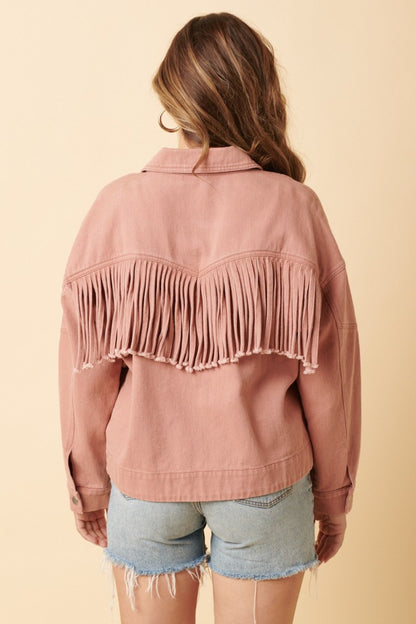 woman wearing western fringe jacket in blush pink back view