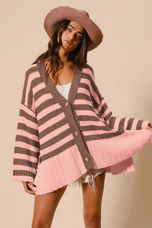 woman wearing oversized striped cardigan in pink and mocha