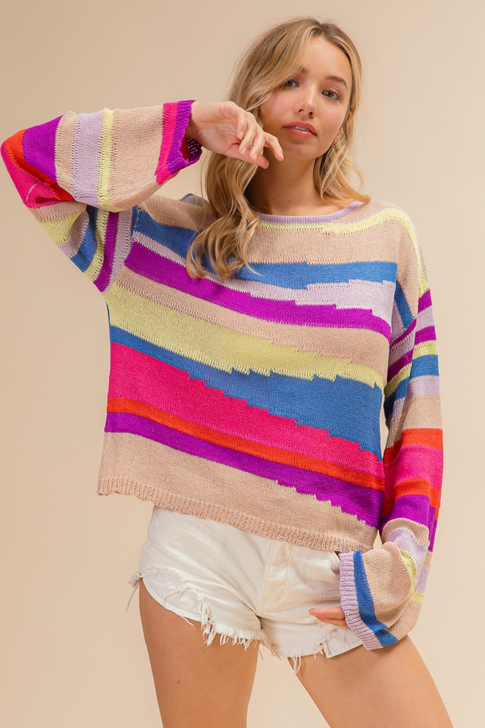 woman wearing colorful knitted rainbow mountain sweater