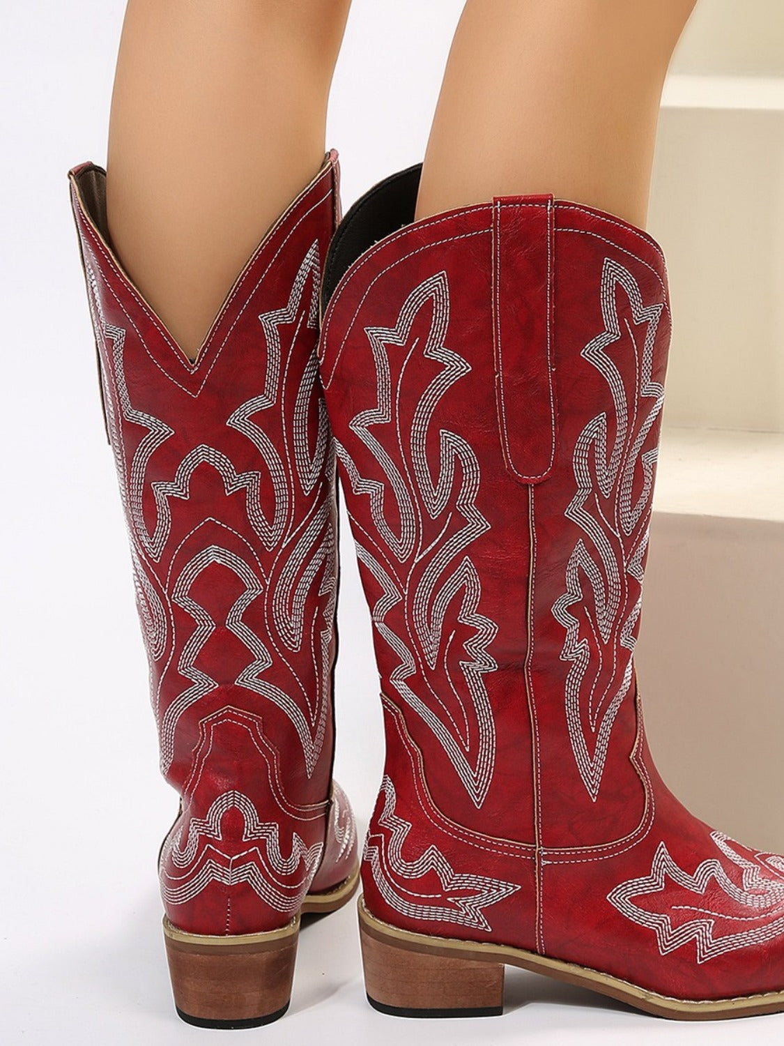 woman wearing western style boots in burgundy red