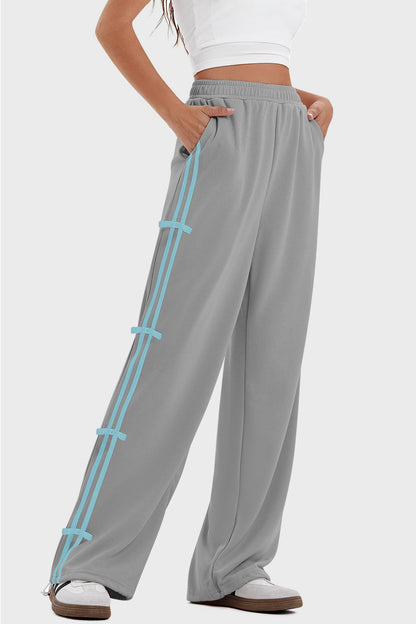 woman wearing bow striped track pants in gray