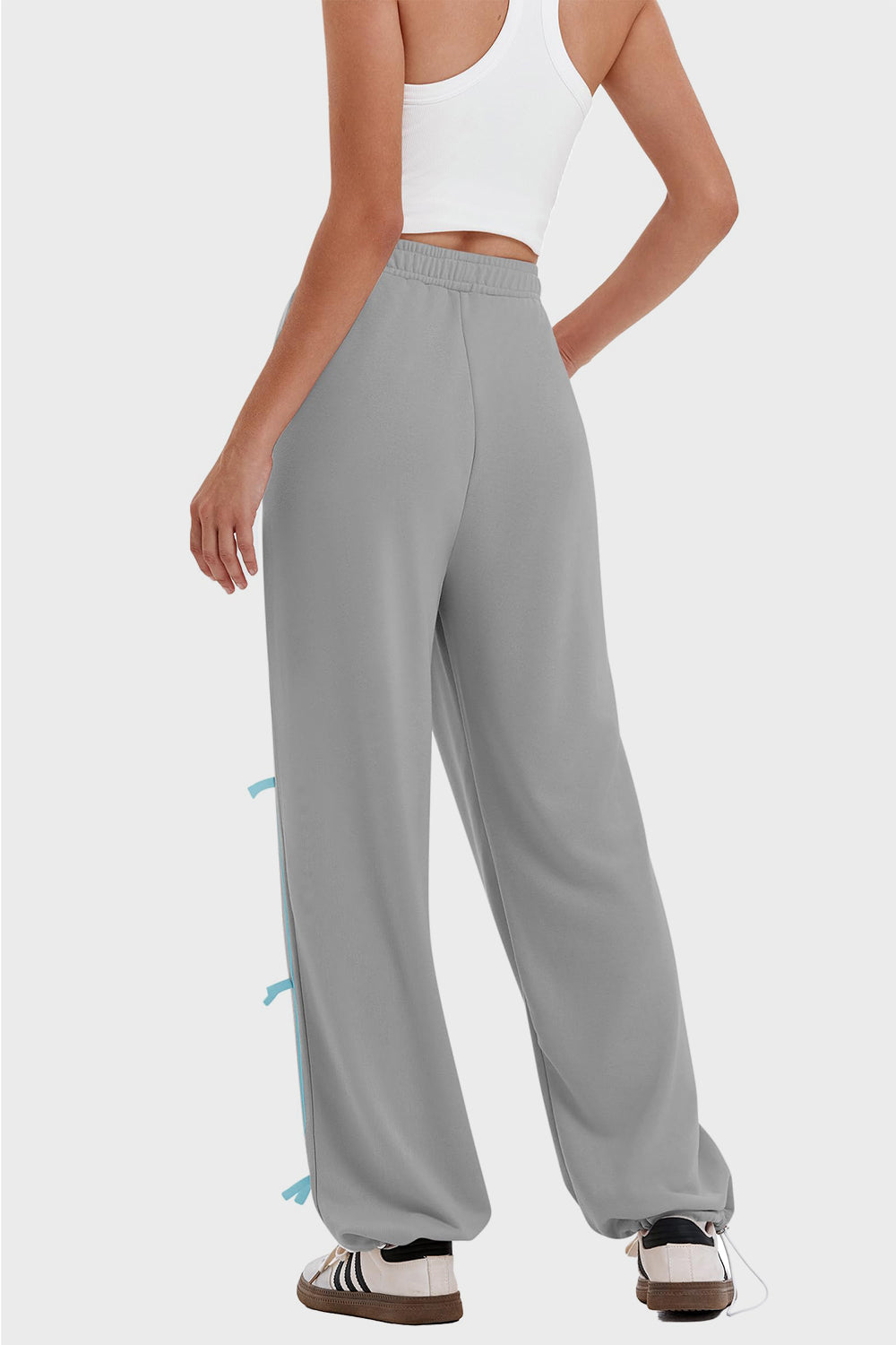 woman wearing bow striped track pants in gray