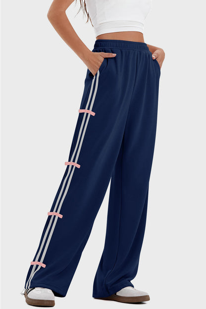 woman wearing bow striped track pants in navy