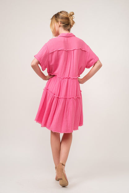 woman wearing cotton shirt dress in pink back view