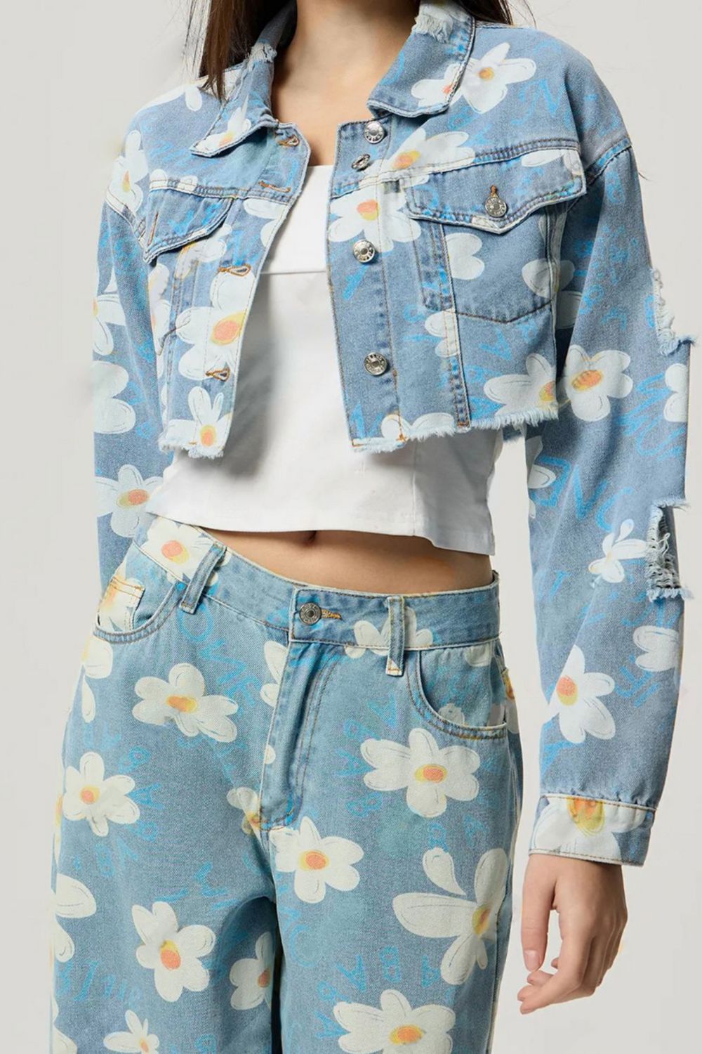 woman wearing cropped denim jacket with flower print