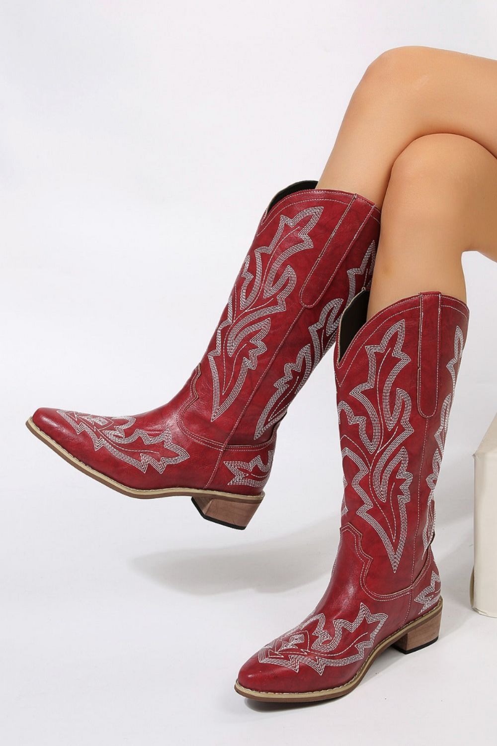 woman wearing western style boots in burgundy red