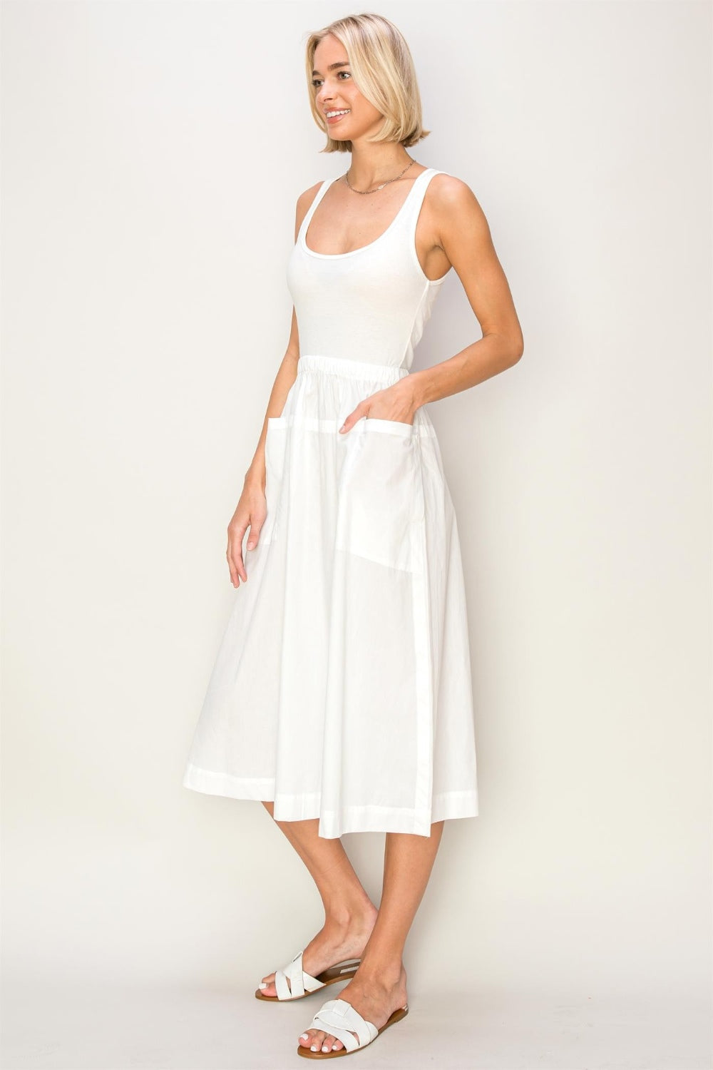 woman wearing white cotton midi tank top dress side view