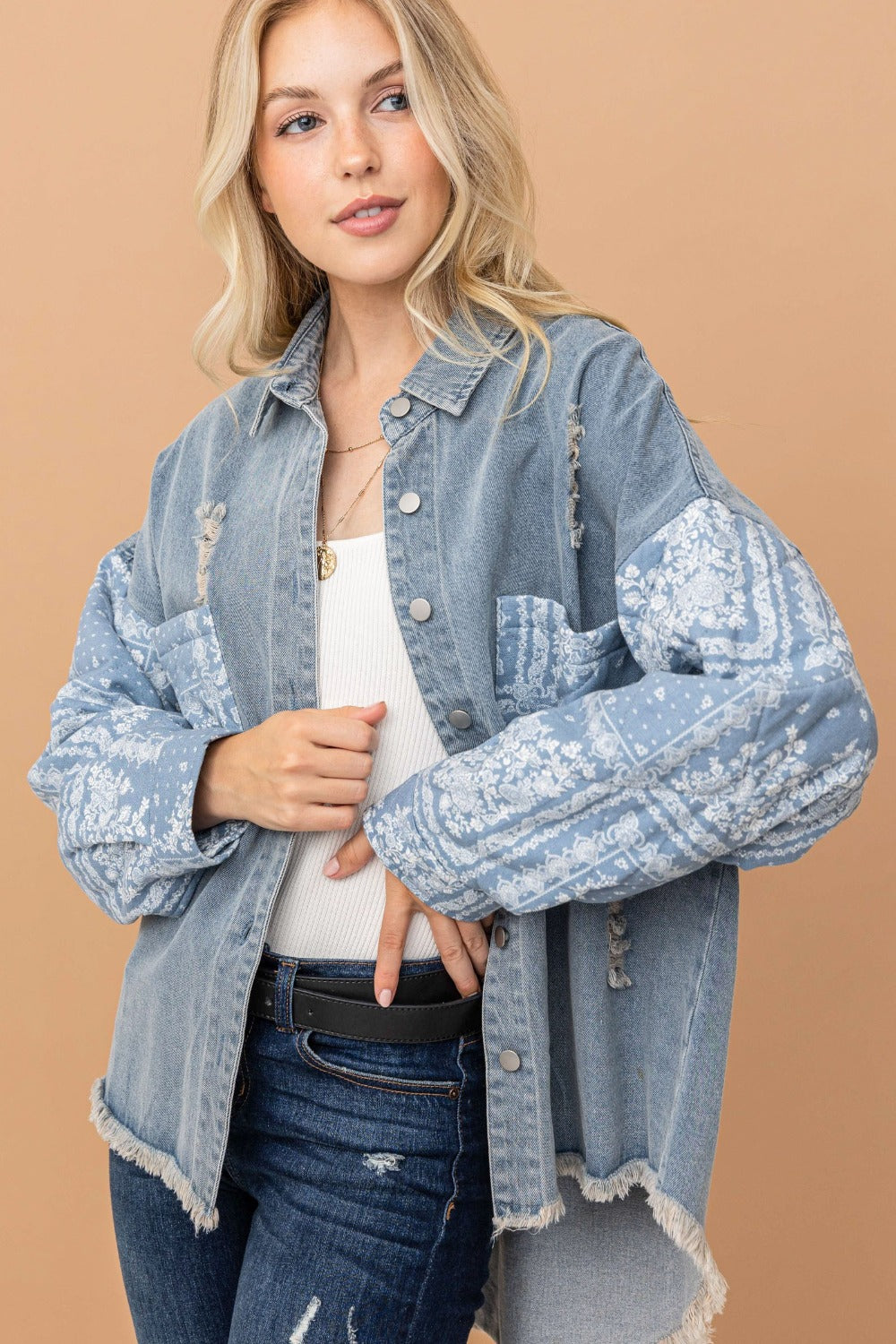 woman wearing high-low denim shacket with paisley pattern