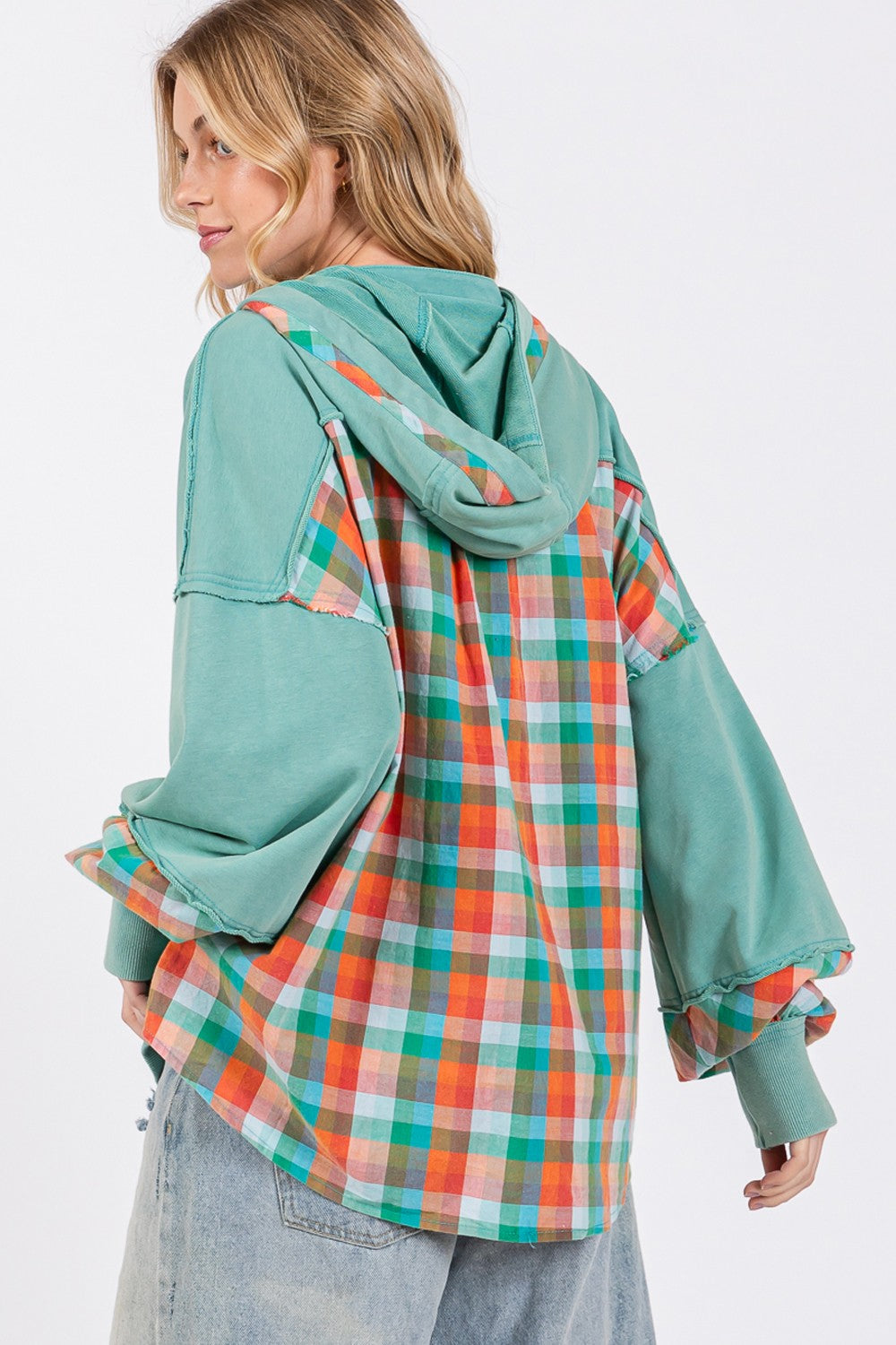 woman wearing plaid print hoodie in eucalyptus green back view