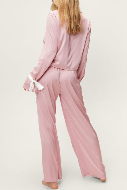 woman wearing silky lounge pant set in pink