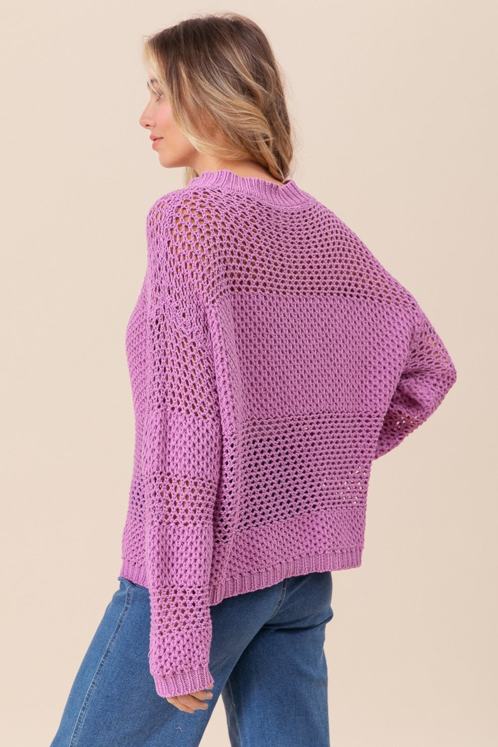 woman wearing purple knit sweater back view