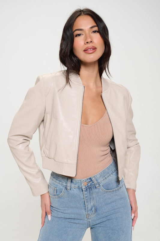 woman wearing cropped bomber jacket in cream vegan leather