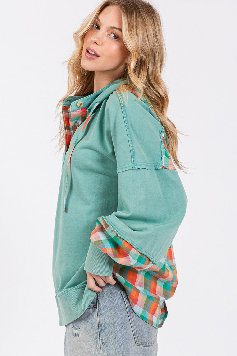 woman wearing plaid print hoodie in eucalyptus green side view