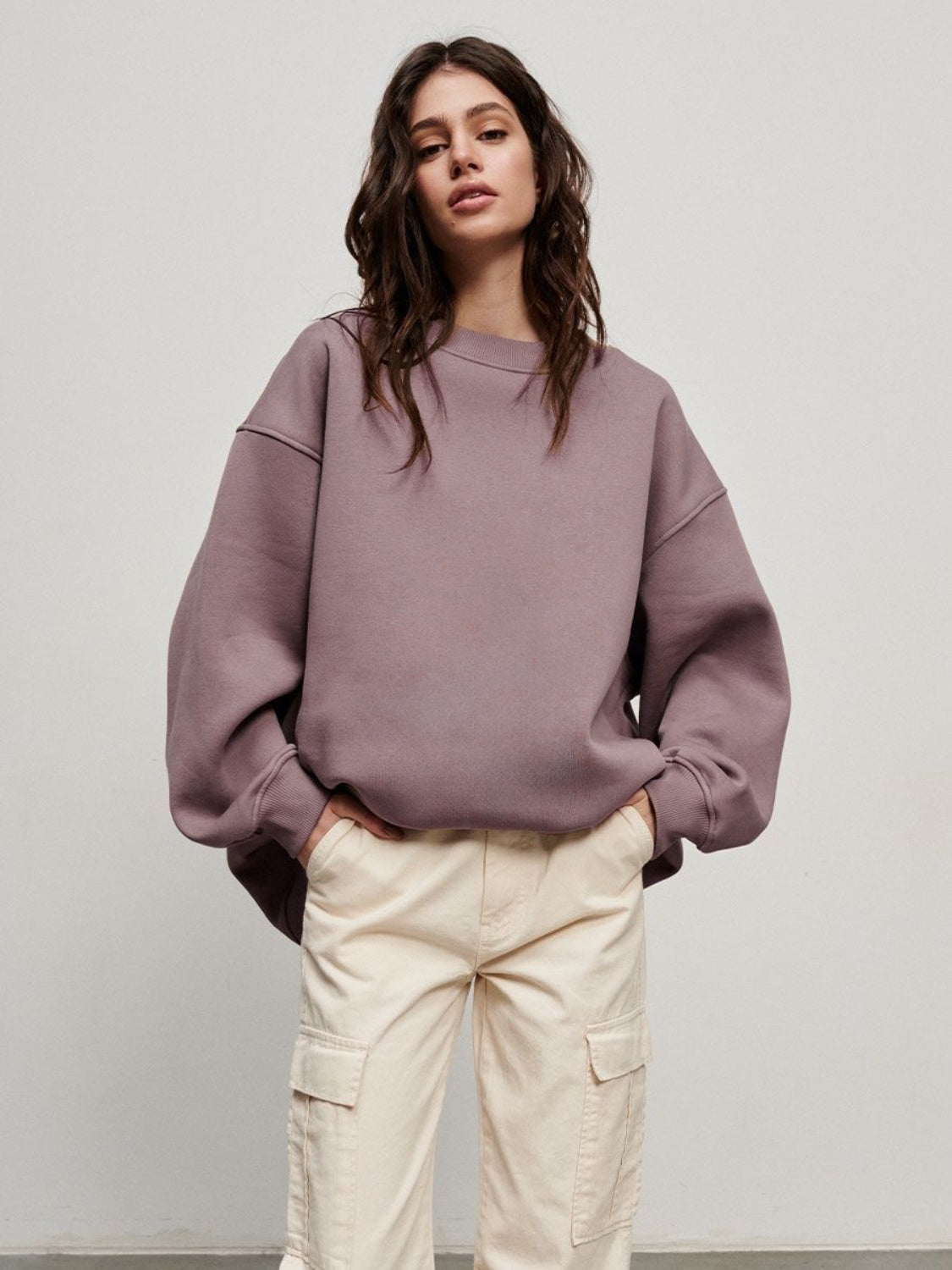 woman wearing oversized cabin sweatshirt in mauve