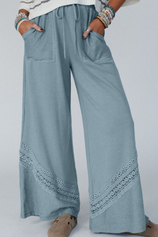 woman wearing lace detail resort pants in light blue