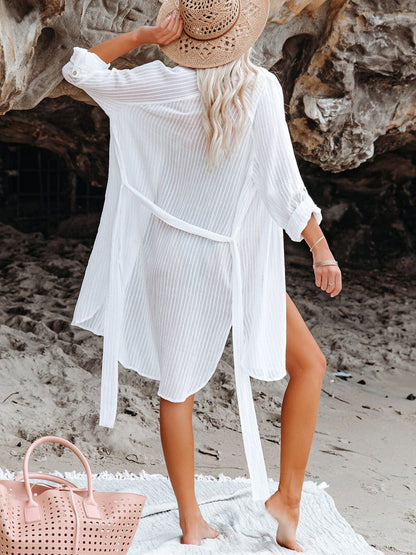 woman on beach wearing beach shirt dress in white back view