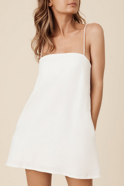 woman wearing the mini resort dress in white