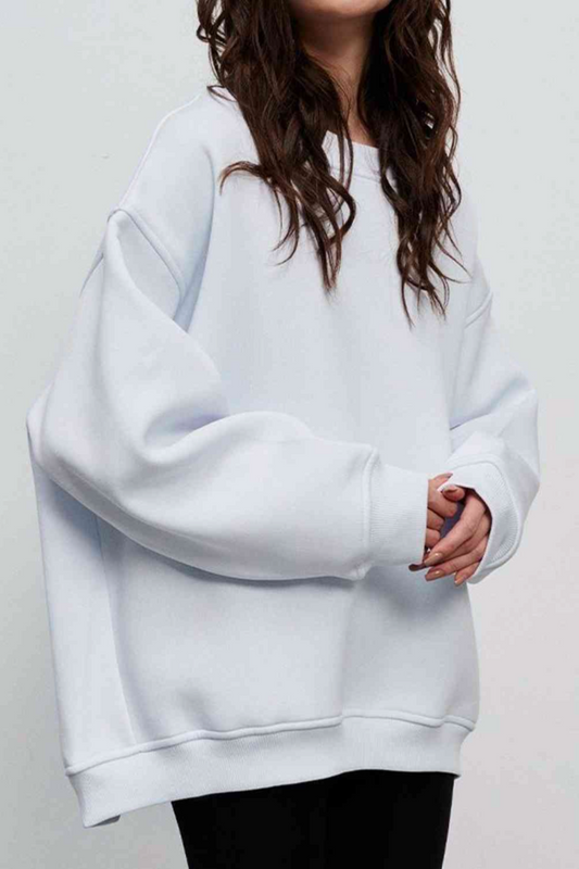 woman wearing oversized cabin sweatshirt in white