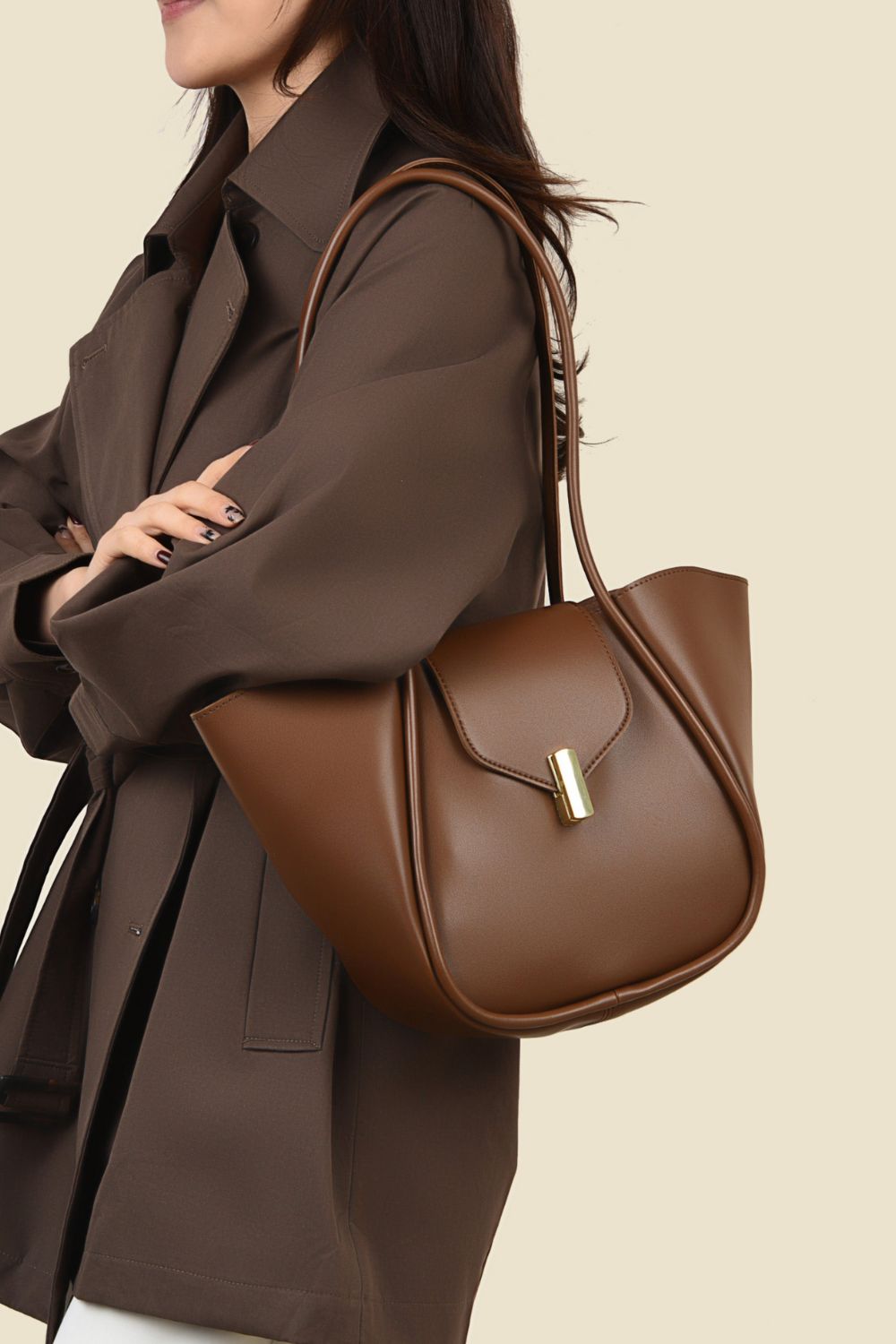 woman wearing shoulder bag with removable pouch in brown